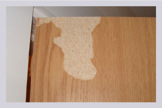 Peeling away from the laminate not only gives a bad and unappealing look but also exposes the wood for further damage.